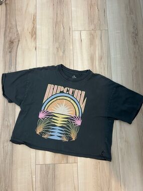 Rip Curl Black Cropped Graphic Tee with Pastel Sunset Motif